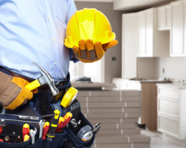 Handyman with a tool belt. House renovation service.